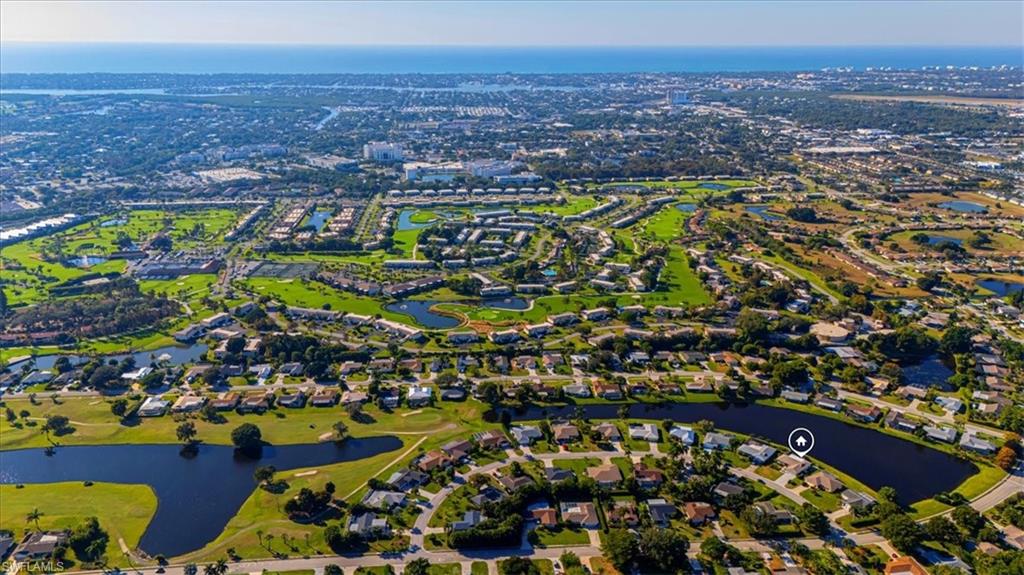 4590 Eagle Key Circle Naples, FL 34112 - Photo 32 of 37 Aerial overview of property's location with a large body of water and nearby suburban area