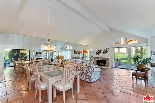 a living room with fireplace furniture and a large window