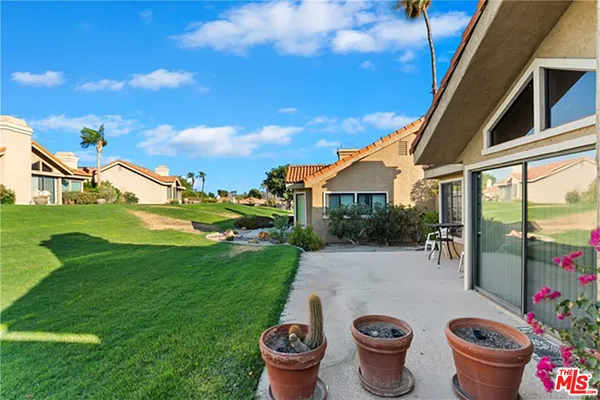 a view of a porch with furniture and a fire pit