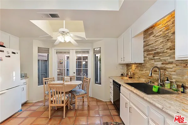 a kitchen with granite countertop lots of counter top space and dining table