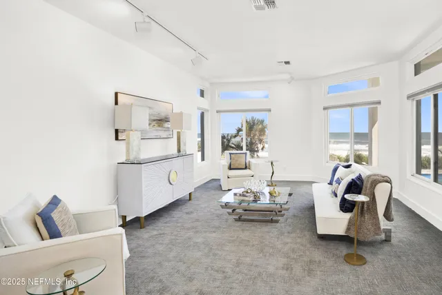 a spacious bedroom with a bed and glass windows