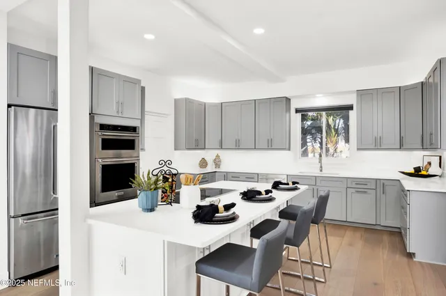 a bathroom with a double vanity sink and a mirror