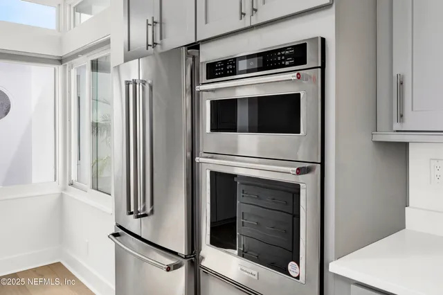 a view of a pathway with a wrought fence