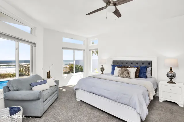 a view of a house with a yard and potted plants