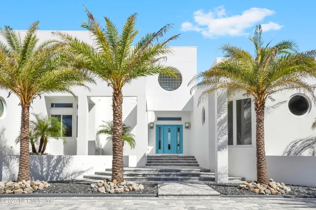 an aerial view of a house with swimming pool garden and patio