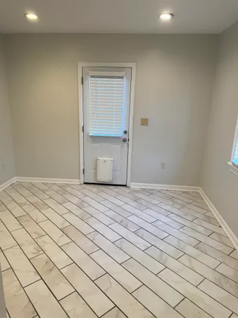 a view of a room with wooden floor and fan