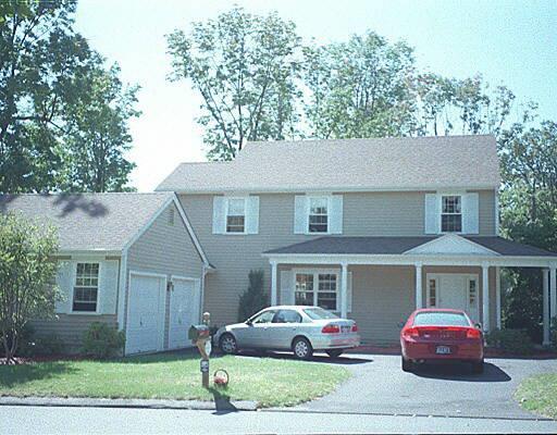 5 Secret Hollow Road, Unit 5 Monroe, CT 06468 - Photo 1 of 1 a front view of a house with a garden and parking