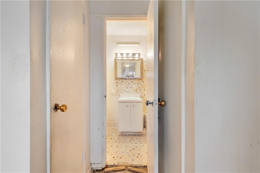1625 Emmons Avenue, Unit 1S Brooklyn, NY 11235 - Photo 9 of 12 a bathroom with a glass door