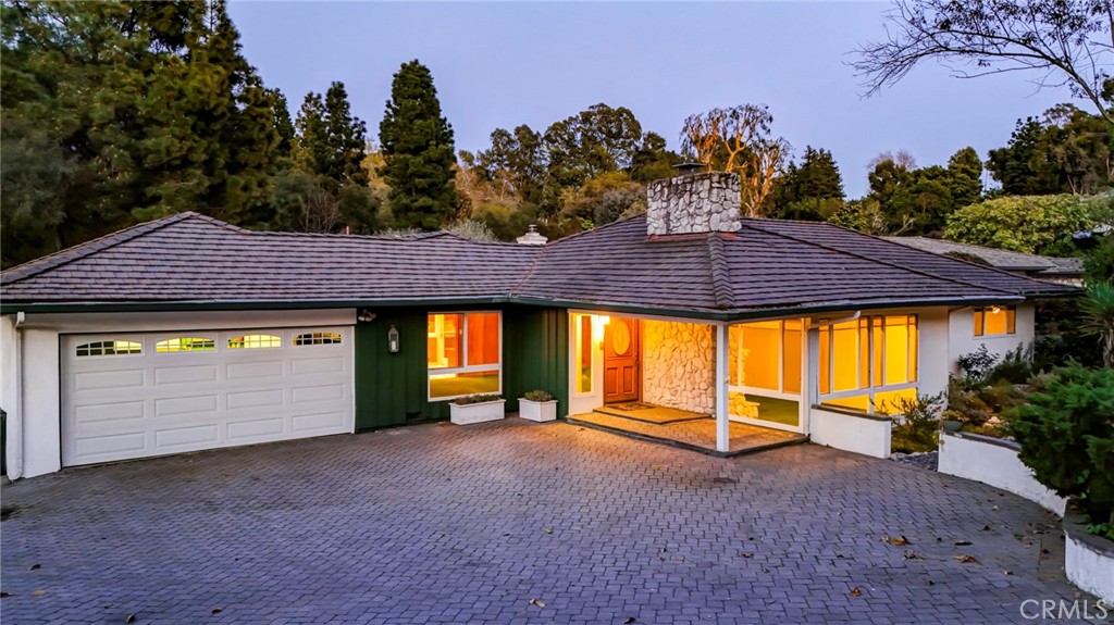 5205 Middlecrest Road Rancho Palos Verdes, CA 90275 - Photo 4 of 36 a front view of a house with a yard and garage