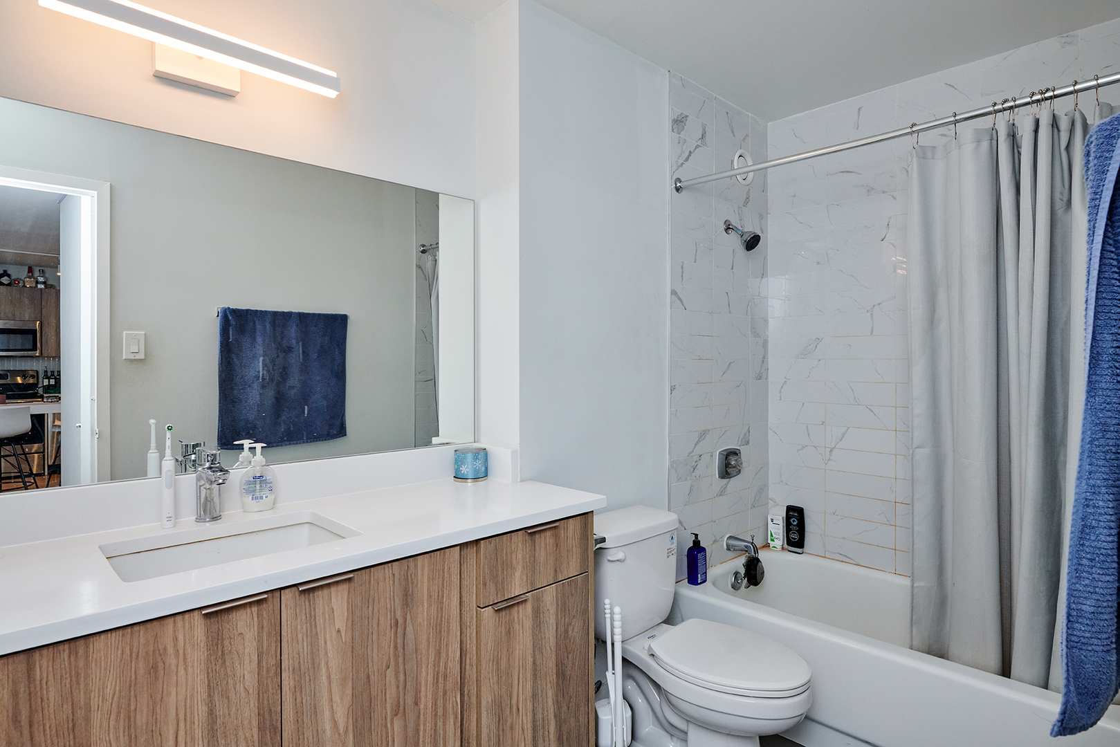 211 East Ohio Street, Unit 614 Chicago, IL 60611 - Photo 11 of 21 a bathroom with a granite countertop sink toilet and shower