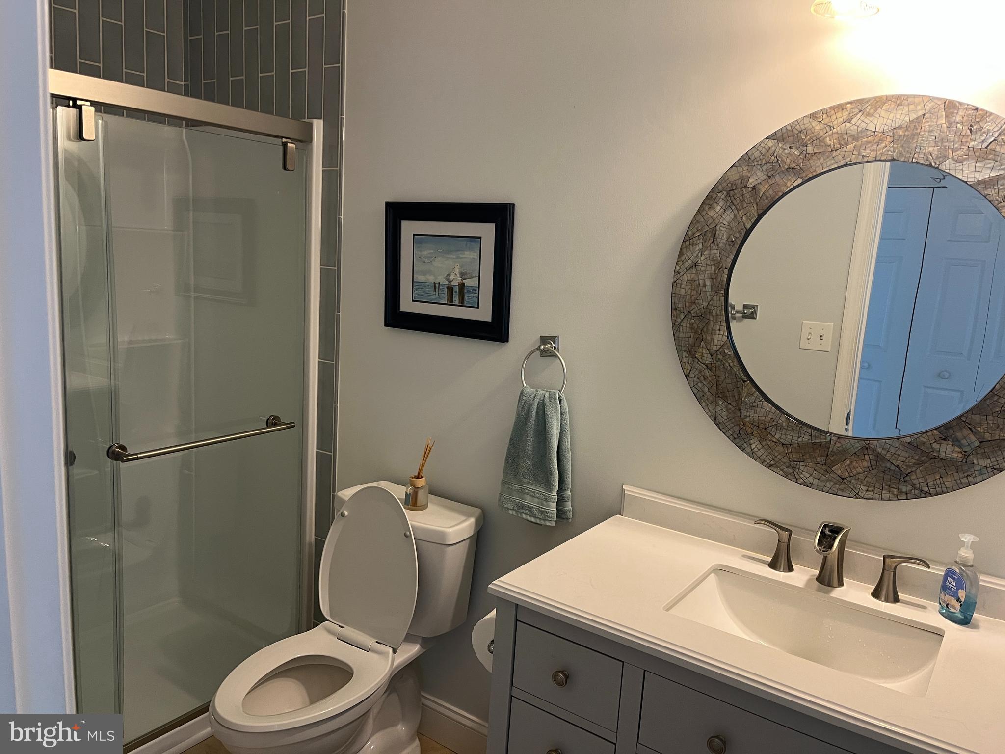3816 Chestnut Road Baltimore, MD 21220 - Photo 22 of 27 a bathroom with a sink mirror toilet and shower