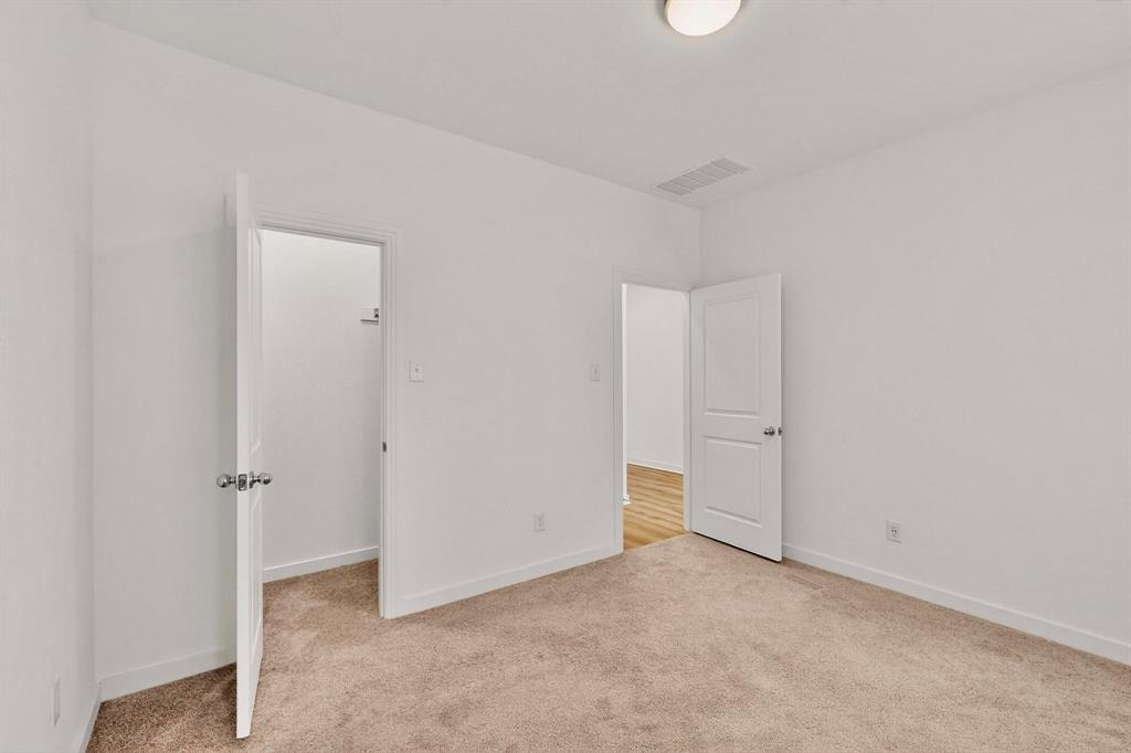 2017 Fall Crk Cove Mesquite, TX 75181 - Photo 21 of 40 Unfurnished bedroom with a walk in closet and light colored carpet