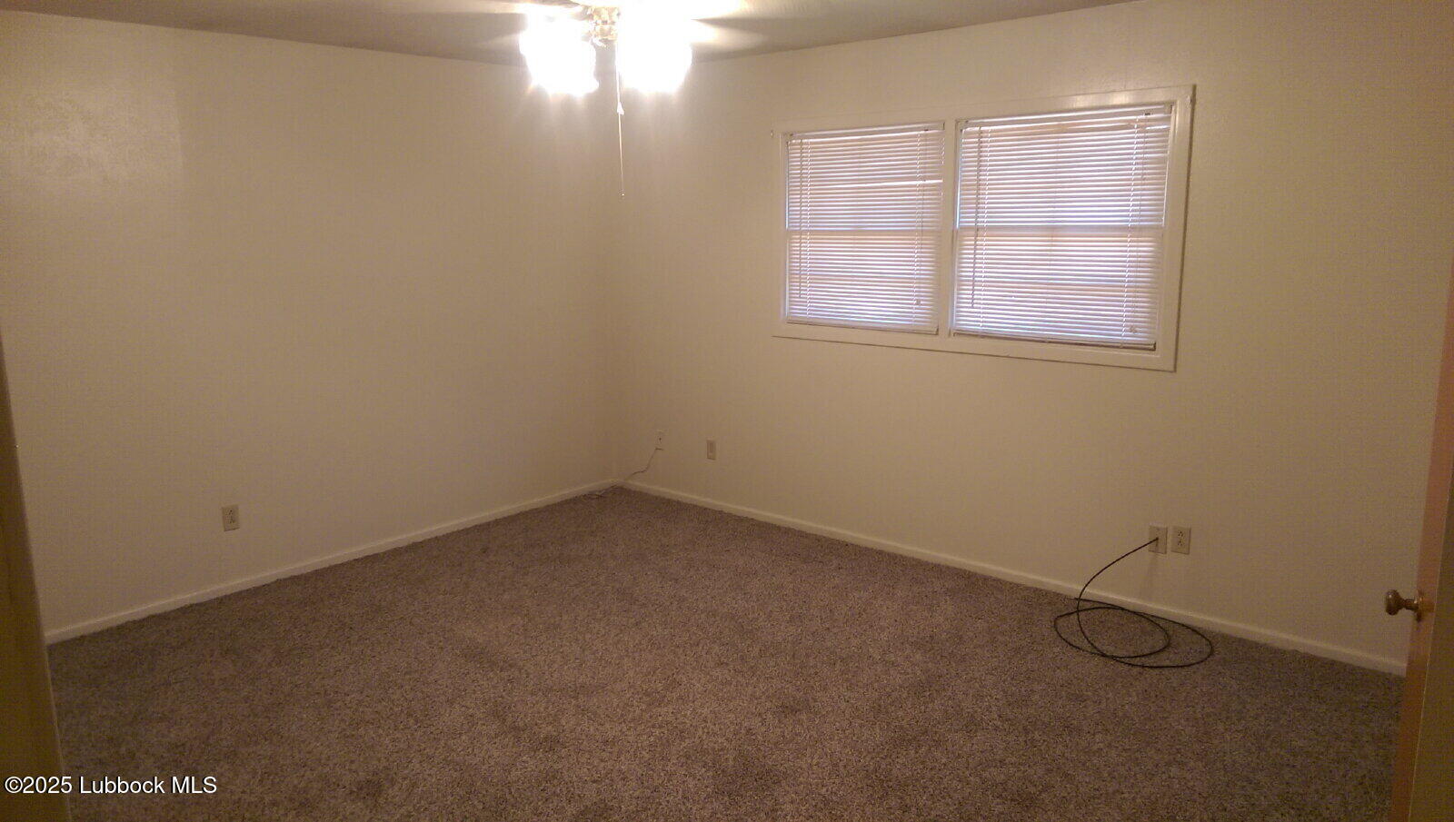2010 54th Street Lubbock, TX 79412 - Photo 15 of 17 an empty room with windows and closet