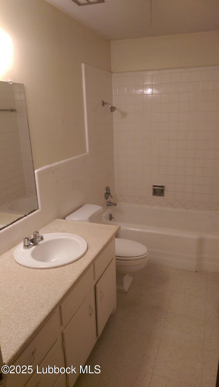 2010 54th Street Lubbock, TX 79412 - Photo 16 of 17 a bathroom with a granite countertop sink a toilet and shower