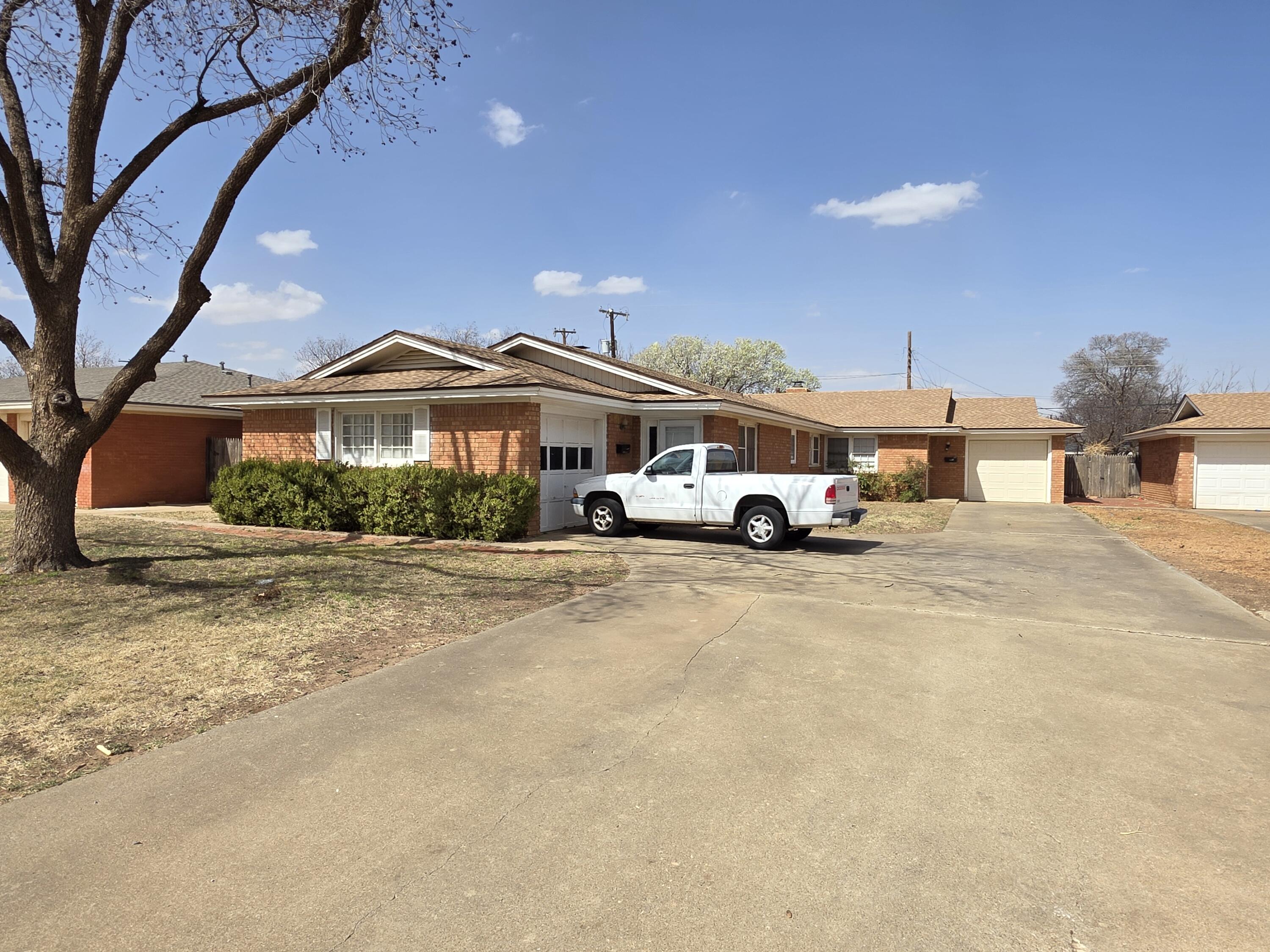 2010 54th Street Lubbock, TX 79412 - Photo 4 of 17 a car parked in front of a house