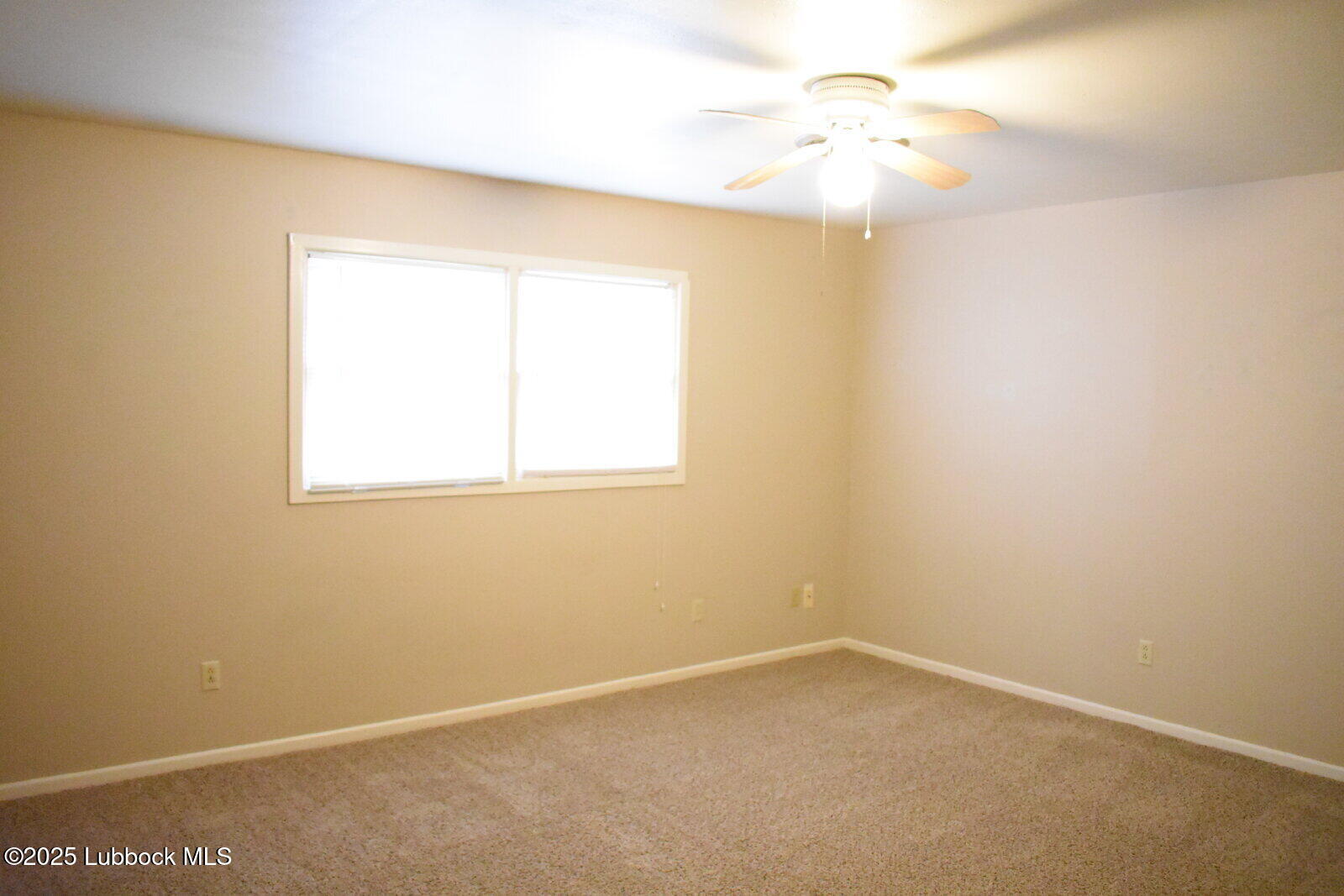 2010 54th Street Lubbock, TX 79412 - Photo 9 of 17 an empty room with a window and a fan