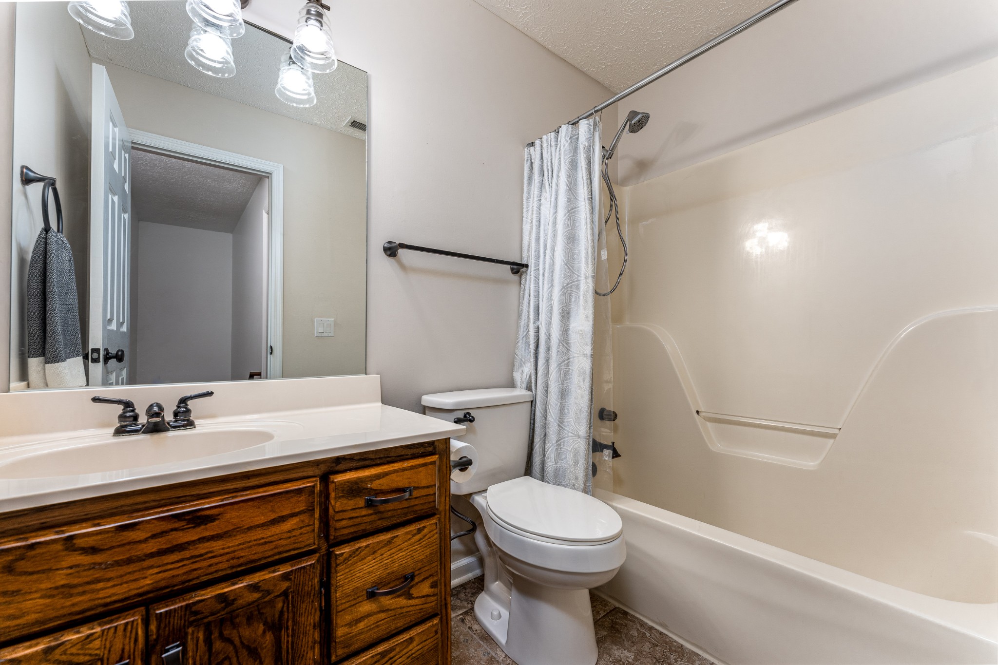 809 Ridgetop Drive Mount Juliet, TN 37122 - Photo 19 of 32 a bathroom with a sink a toilet a mirror and shower