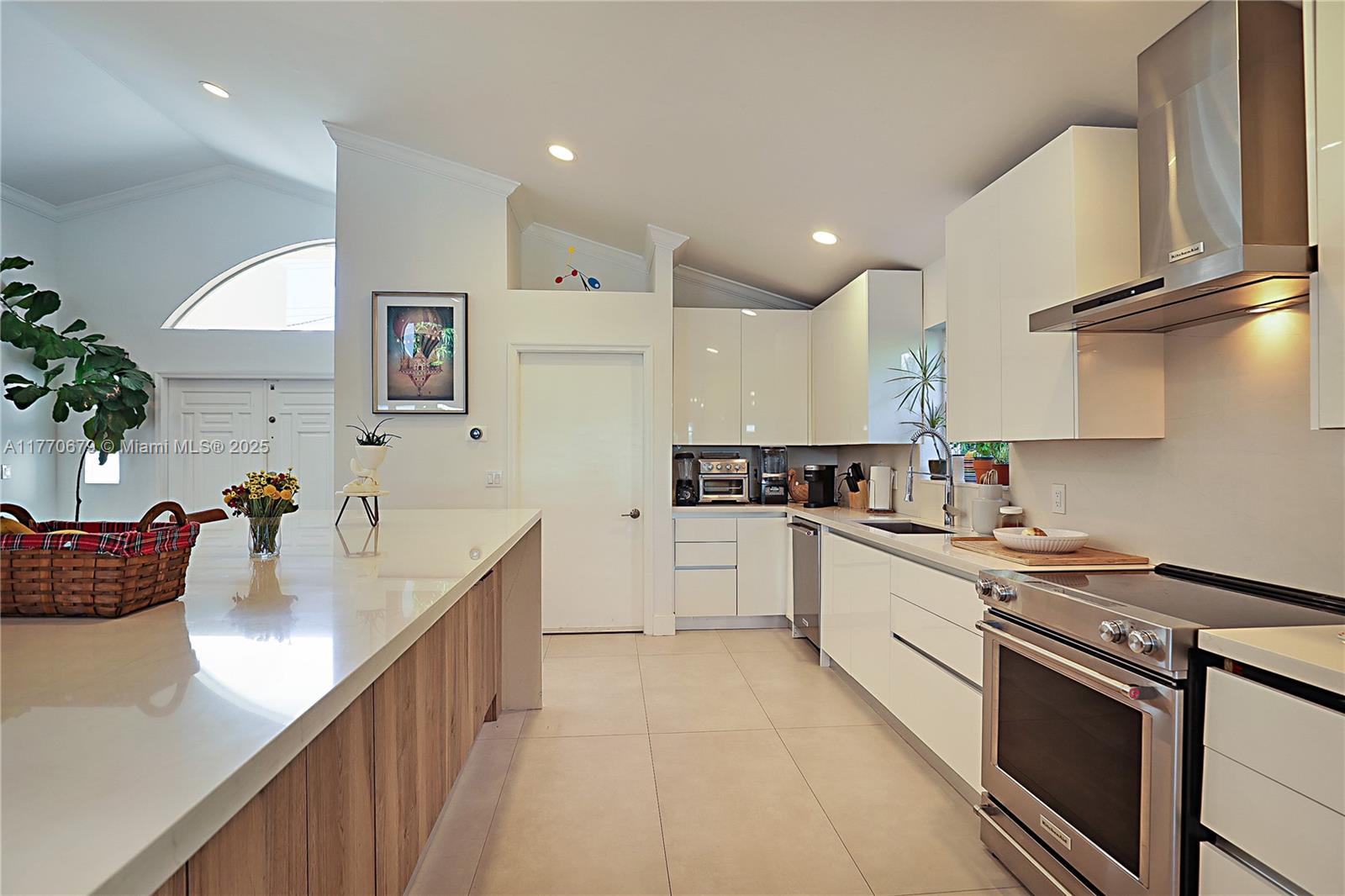8919 Byron Avenue Surfside, FL 33154 - Photo 14 of 51 a kitchen with stainless steel appliances granite countertop a sink counter space cabinets and a stove