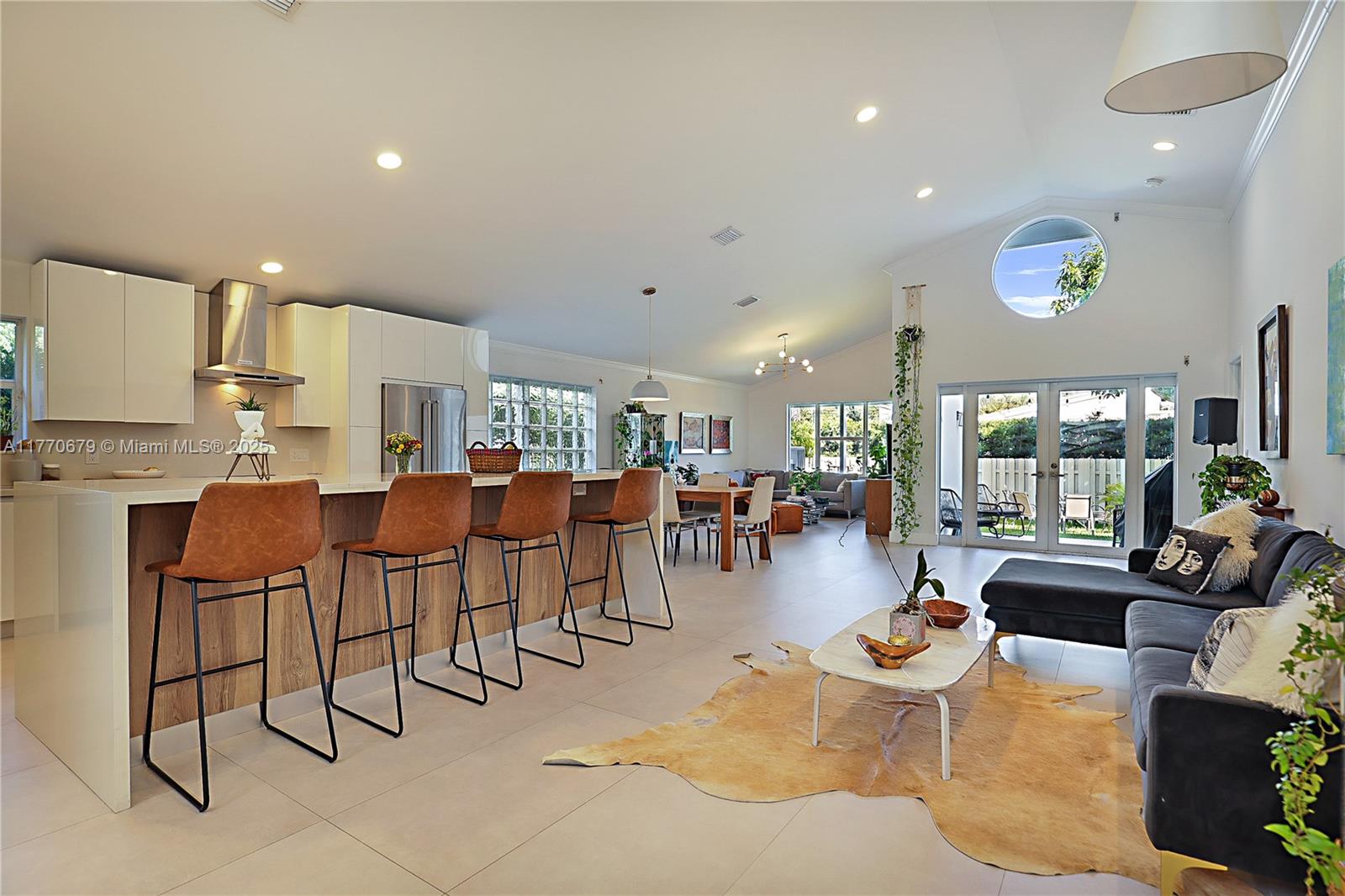 8919 Byron Avenue Surfside, FL 33154 - Photo 16 of 51 a living room with lots of furniture and a large window