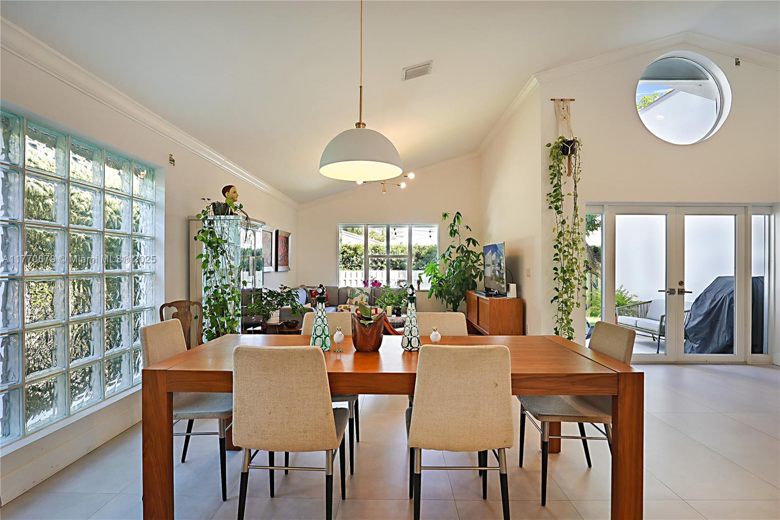 8919 Byron Avenue Surfside, FL 33154 - Photo 19 of 51 a view of a dining room with furniture a chandelier and wooden floor