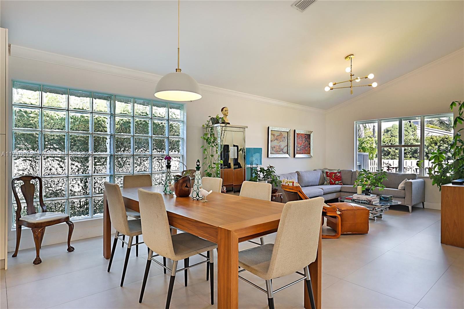 8919 Byron Avenue Surfside, FL 33154 - Photo 20 of 51 a living room with patio furniture and a chandelier
