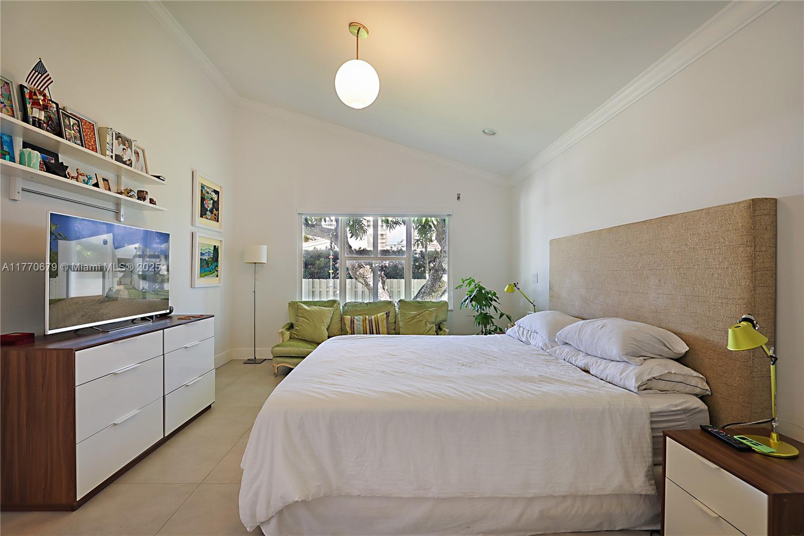 8919 Byron Avenue Surfside, FL 33154 - Photo 27 of 51 a bedroom with a bed and large window