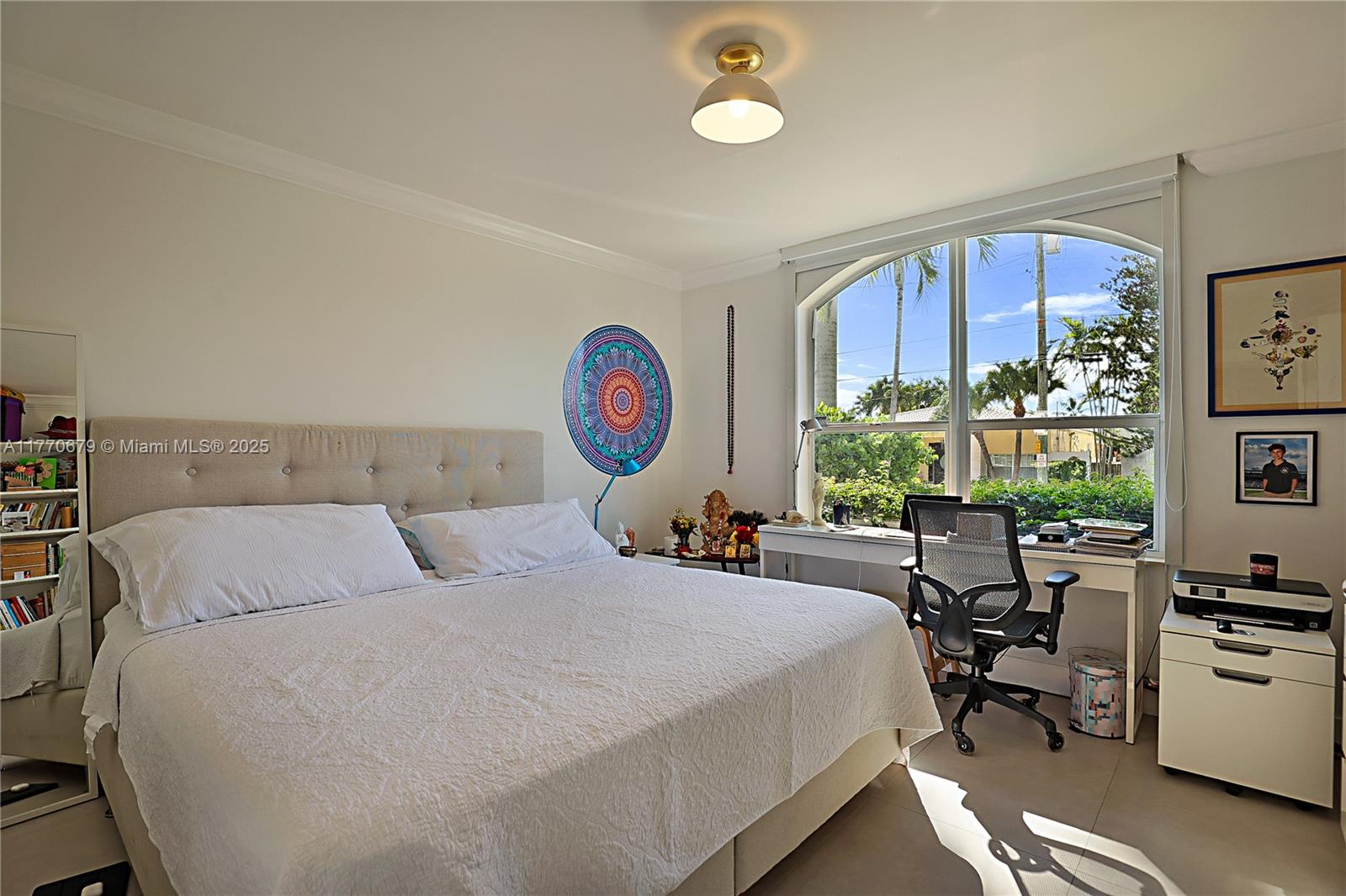 8919 Byron Avenue Surfside, FL 33154 - Photo 32 of 51 a bed room with a bed and a chair