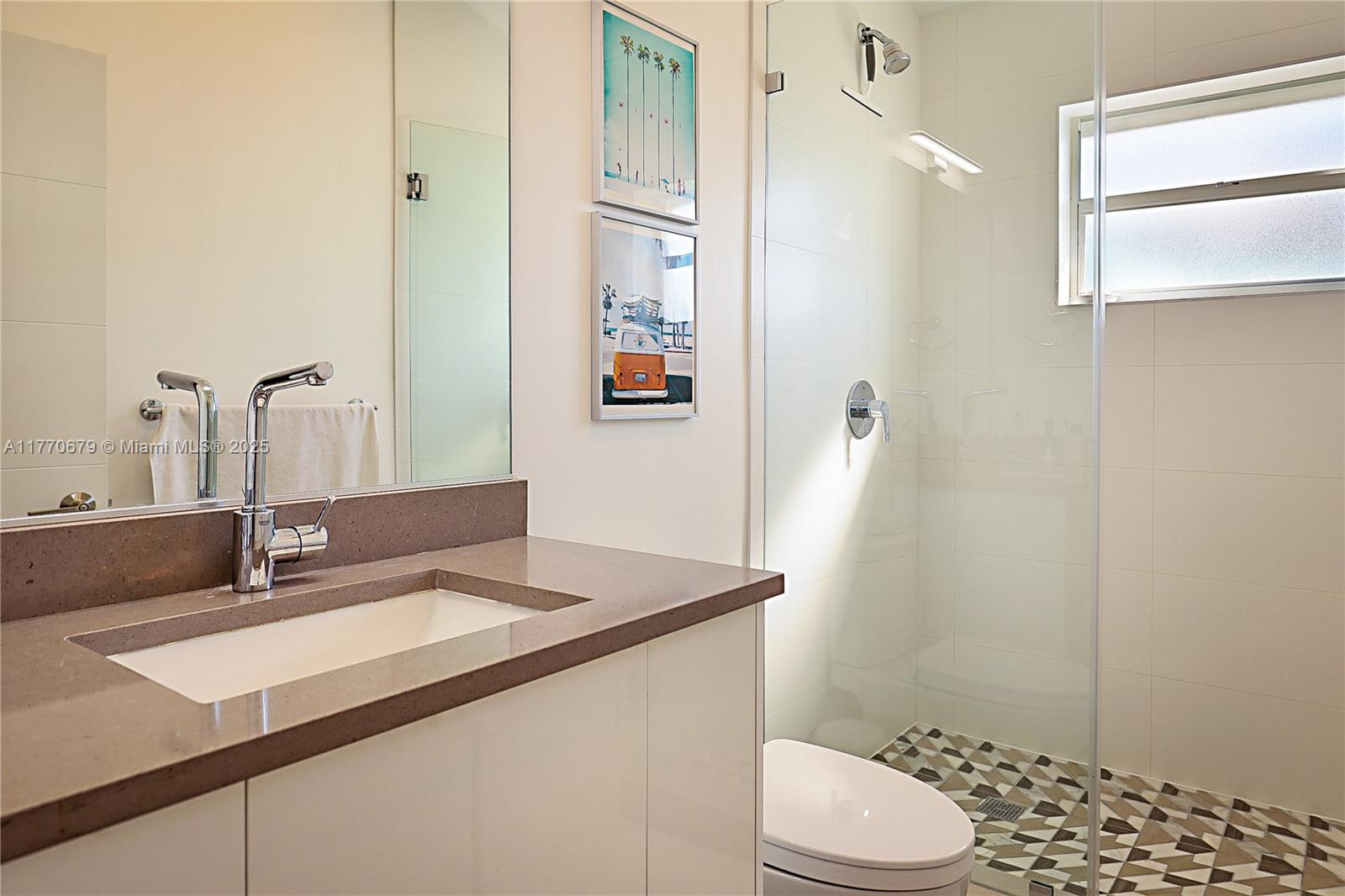 8919 Byron Avenue Surfside, FL 33154 - Photo 33 of 51 a bathroom with a sink a toilet and shower