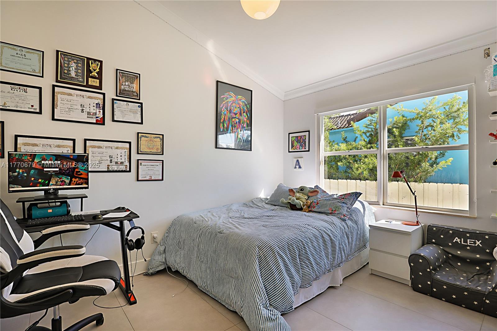 8919 Byron Avenue Surfside, FL 33154 - Photo 34 of 51 a bedroom with a bed a couch and a window