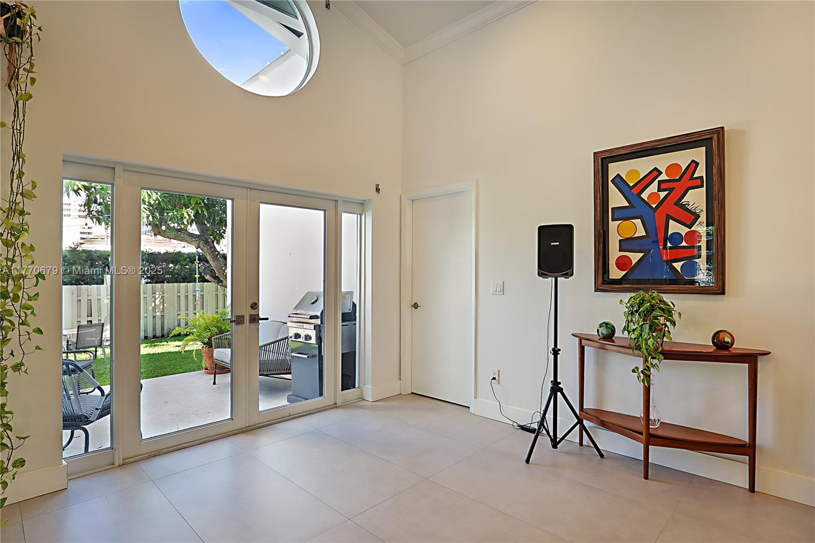 8919 Byron Avenue Surfside, FL 33154 - Photo 35 of 51 a living room with furniture and a floor to ceiling window