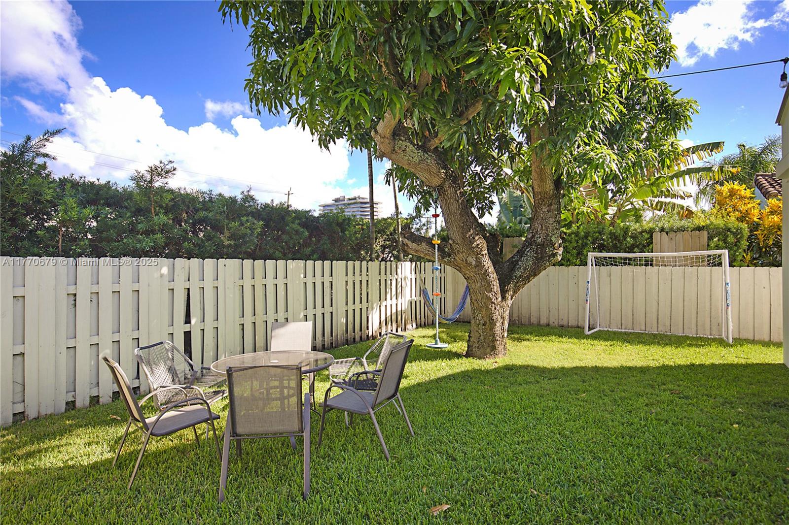 8919 Byron Avenue Surfside, FL 33154 - Photo 39 of 51 a view of a chairs and table in backyard