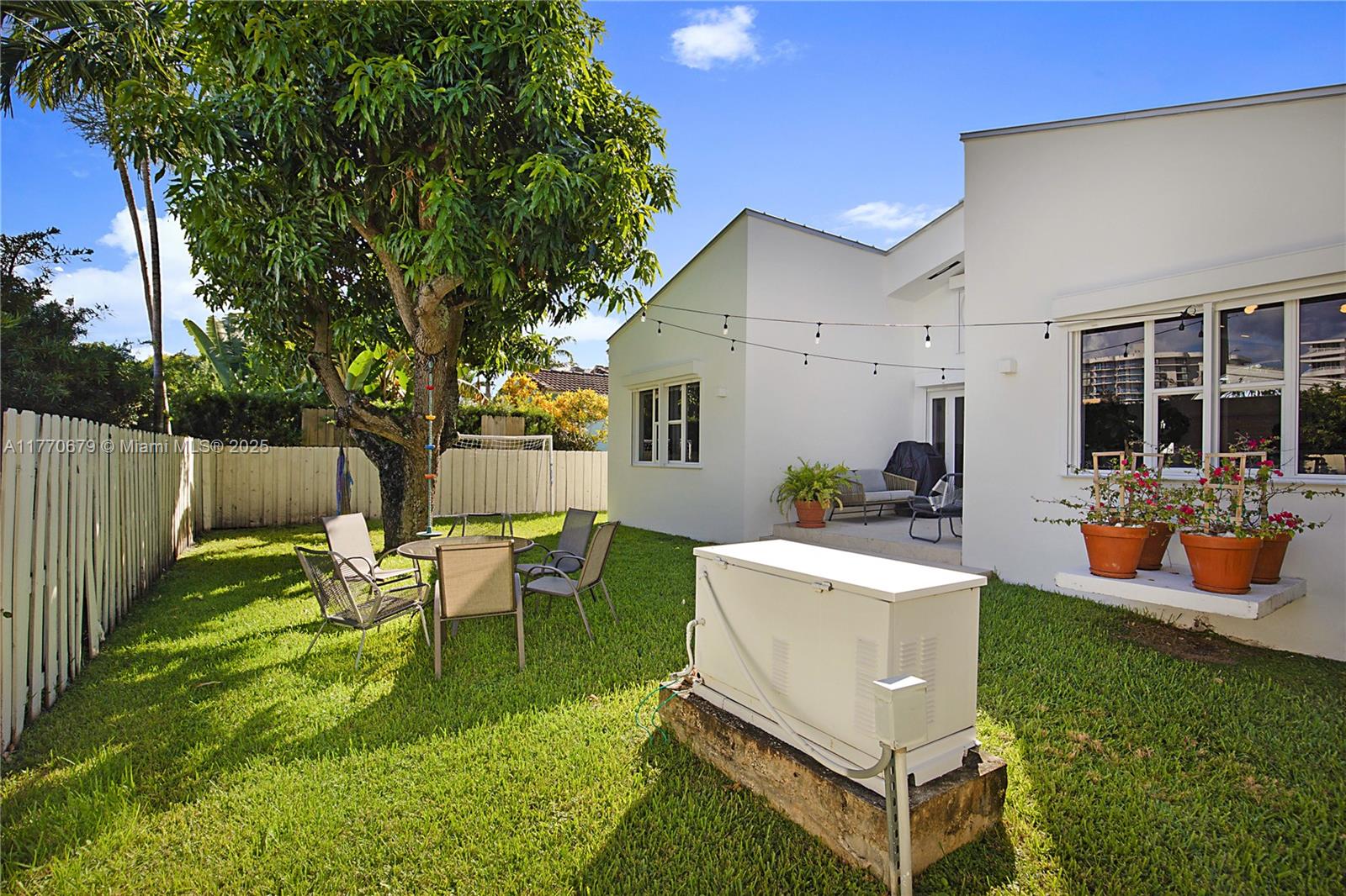 8919 Byron Avenue Surfside, FL 33154 - Photo 40 of 51 a view of a house with backyard sitting area and garden