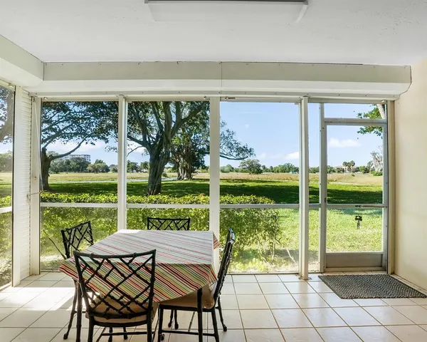 a view of a porch with furniture and garden