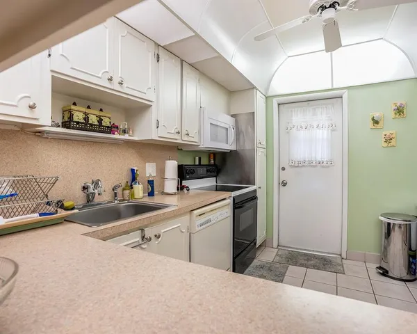 a kitchen with stainless steel appliances granite countertop a sink and cabinets