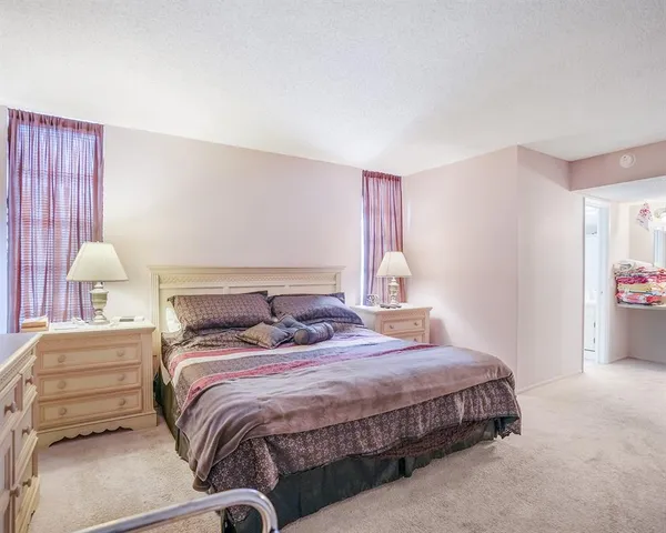 a bedroom with a bed and a night stand