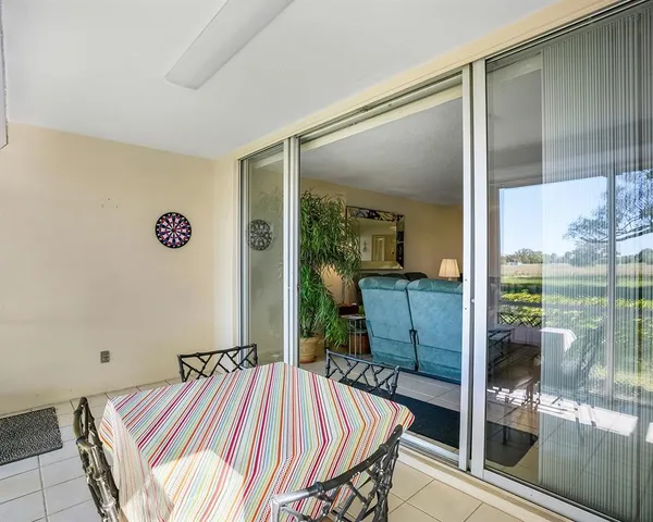 a bedroom with a bed and glass door