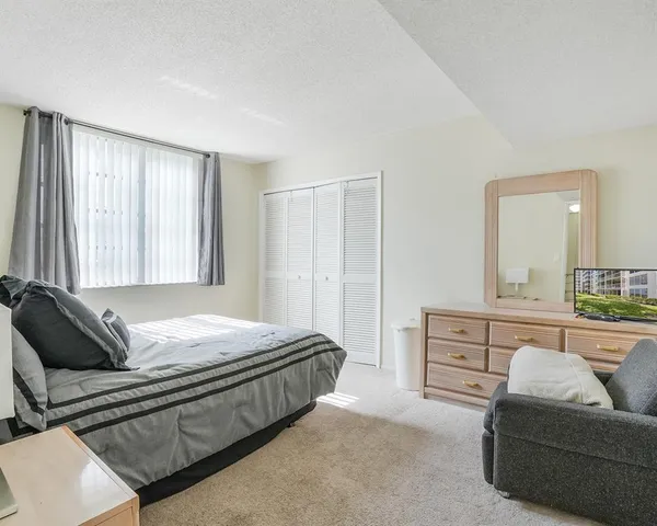 a bedroom with bed and window