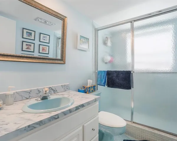 a bathroom with a sink toilet and mirror