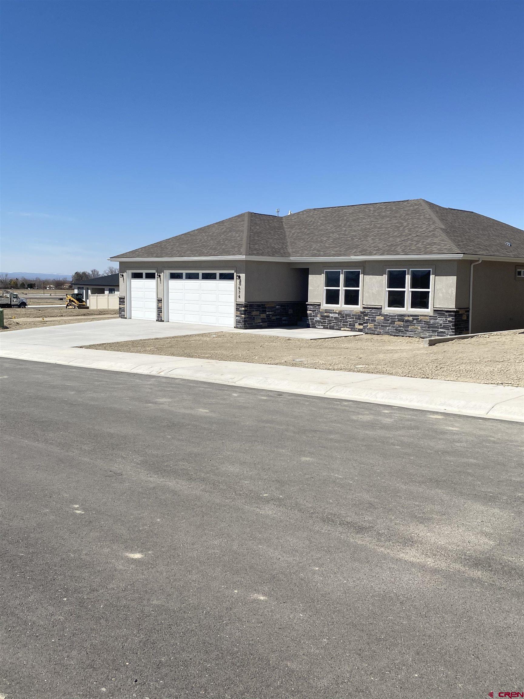 a view of a big house with a big yard and large trees