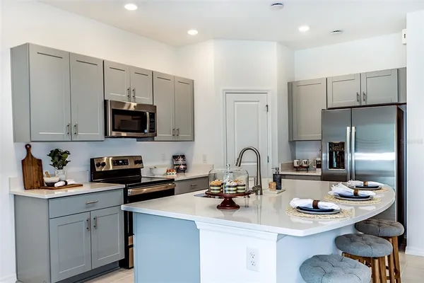 a kitchen with a stove a table and chairs
