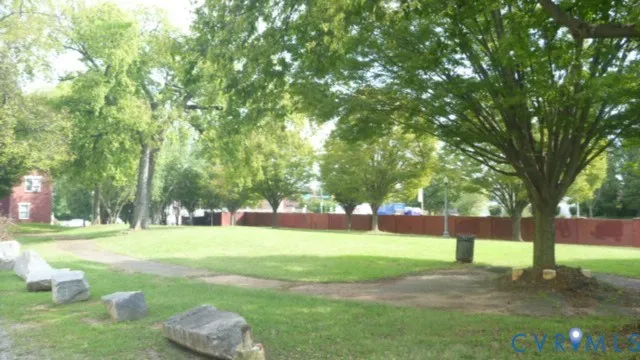 a view of a house with a big yard and palm trees