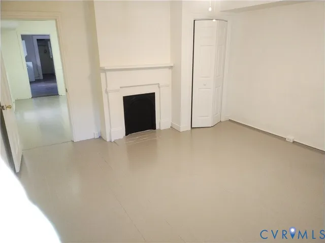 a view of empty room with fireplace