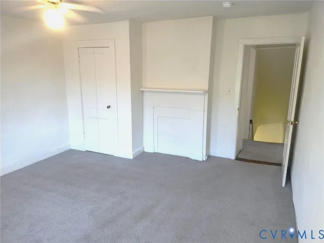 a view of an empty room and closet area