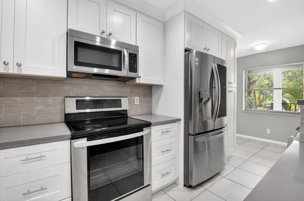 an aerial view of residential houses with outdoor space and river view