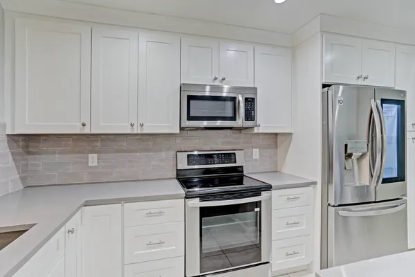 an aerial view of a house with a garden and lake view