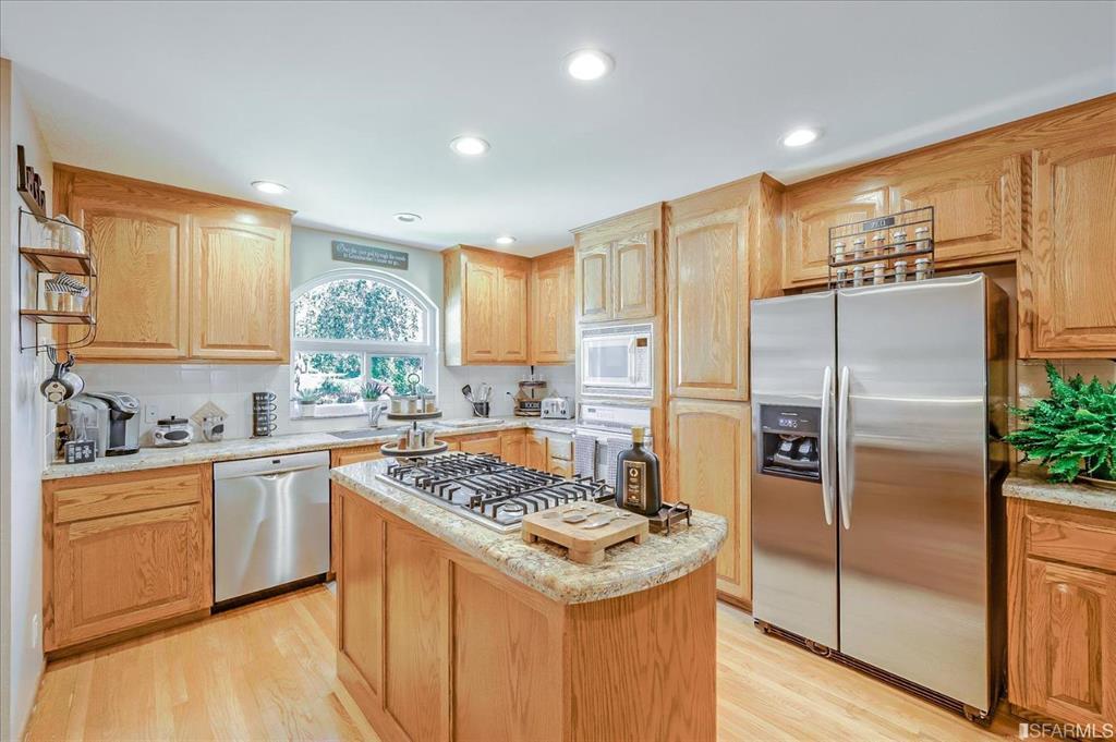 5 Maple Way San Carlos, CA 94070 - Photo 3 of 5 a kitchen with stainless steel appliances granite countertop a stove a refrigerator a sink a counter space and cabinets