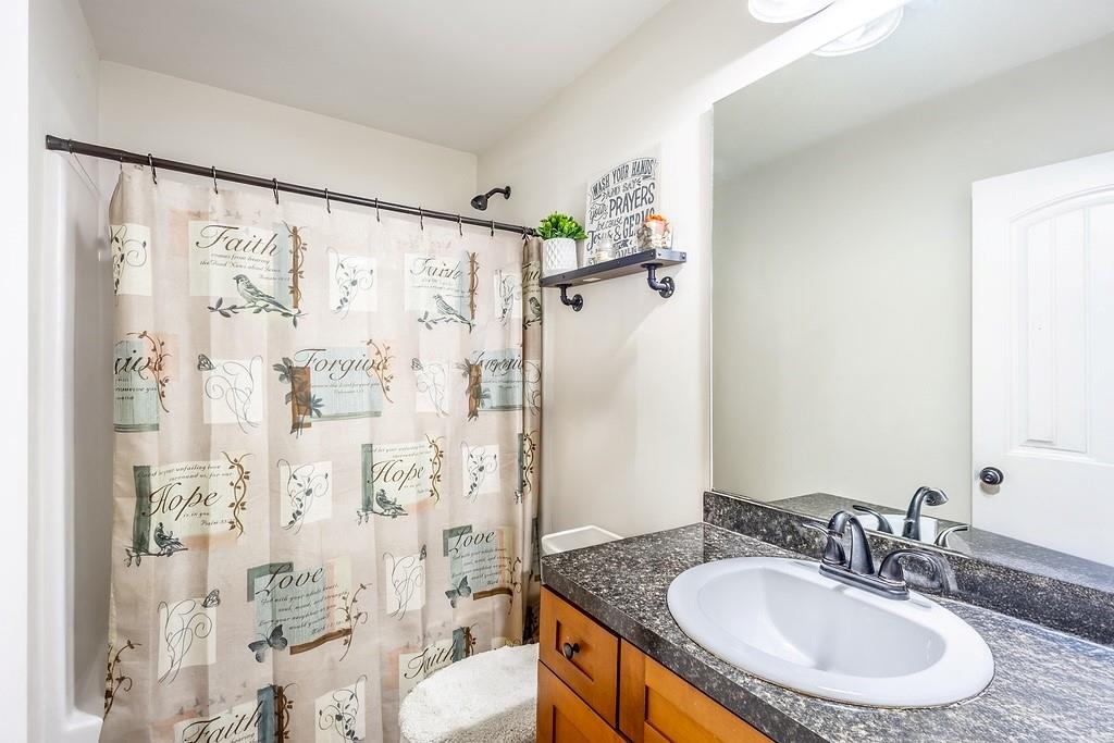 3907 Robin Court Acworth, GA 30101 - Photo 12 of 29 a bathroom with a granite countertop shower sink and mirror