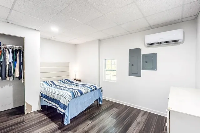 a bedroom with a bed and a window