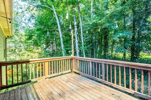 a view of balcony with deck and yard