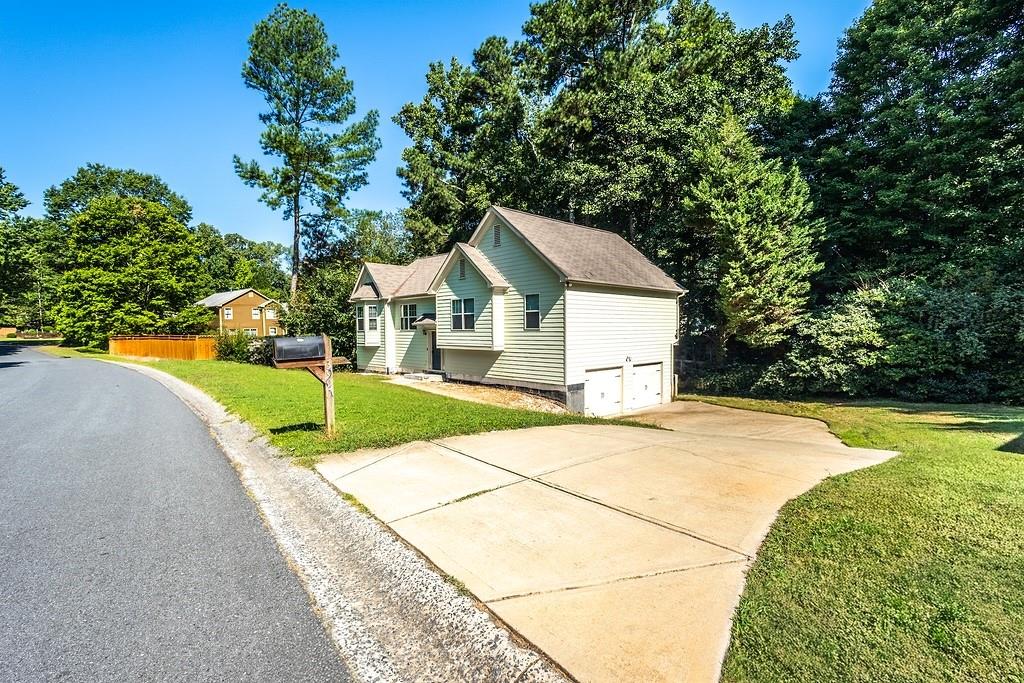 3907 Robin Court Acworth, GA 30101 - Photo 3 of 29 a front view of a house with a yard garage and outdoor seating
